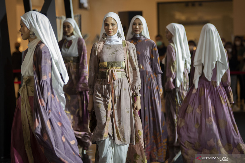 Several models display modest fashion clothing during the 2021 Muslim Fashion Festival in Jakarta.